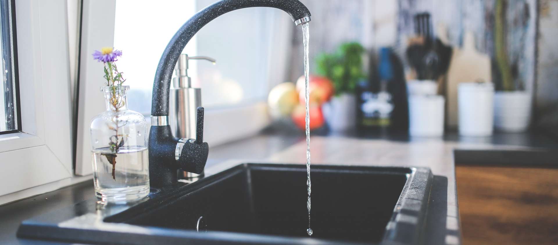 Kitchen sink tap with running water 