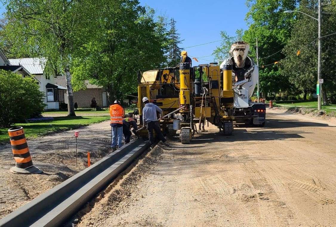 a construction photo of concrete curbs being installed on Parkhill Main Street 